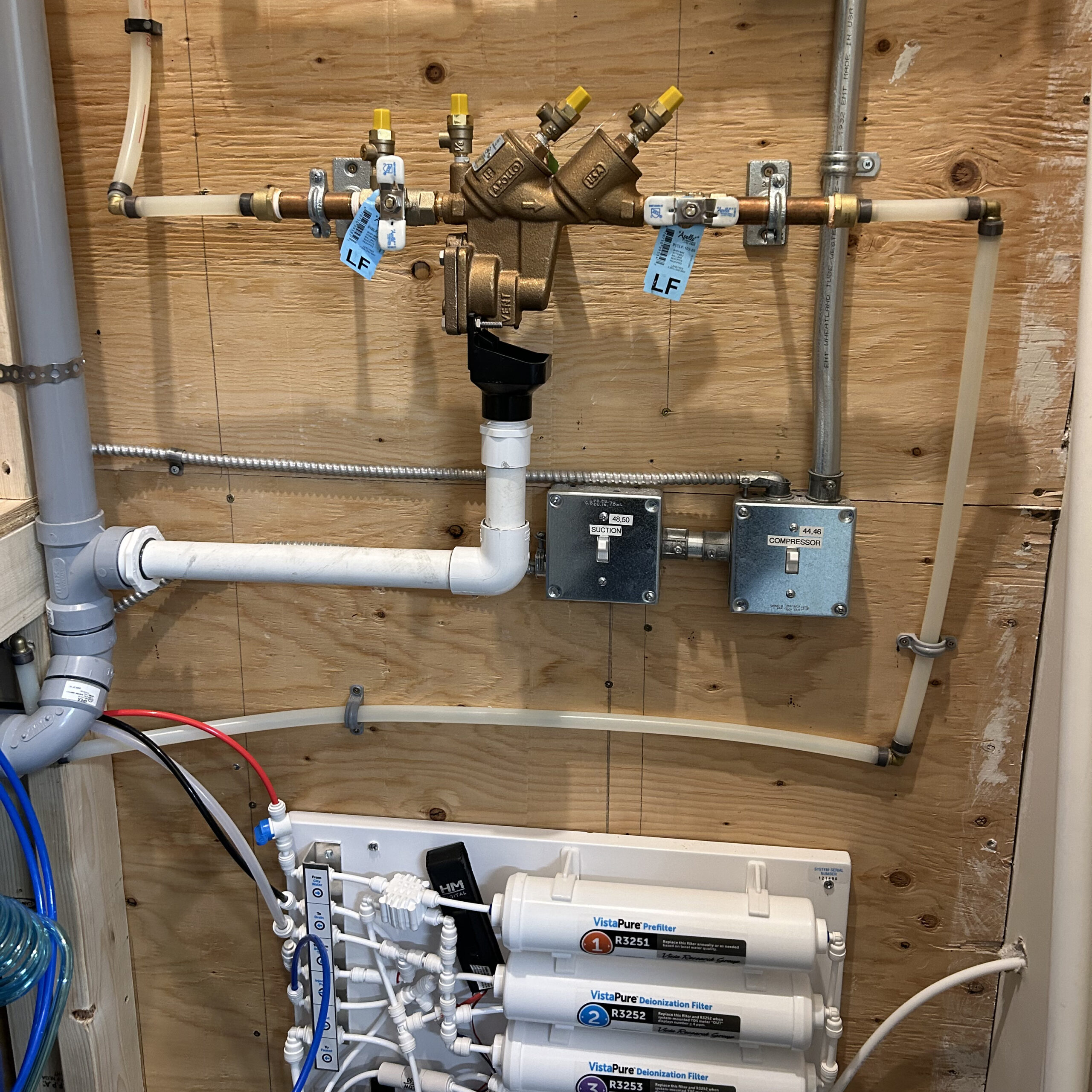 Water pipes and filtration system connected in house's utilities area.